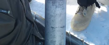 a group of people standing next to a pole in the snow