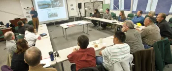 a group of people sitting around tables in a room