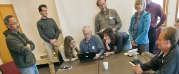 a group of people standing around a large map