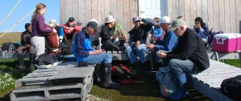 a group of people sitting outside of a building