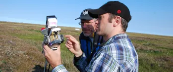 a couple of men standing next to each other in a field